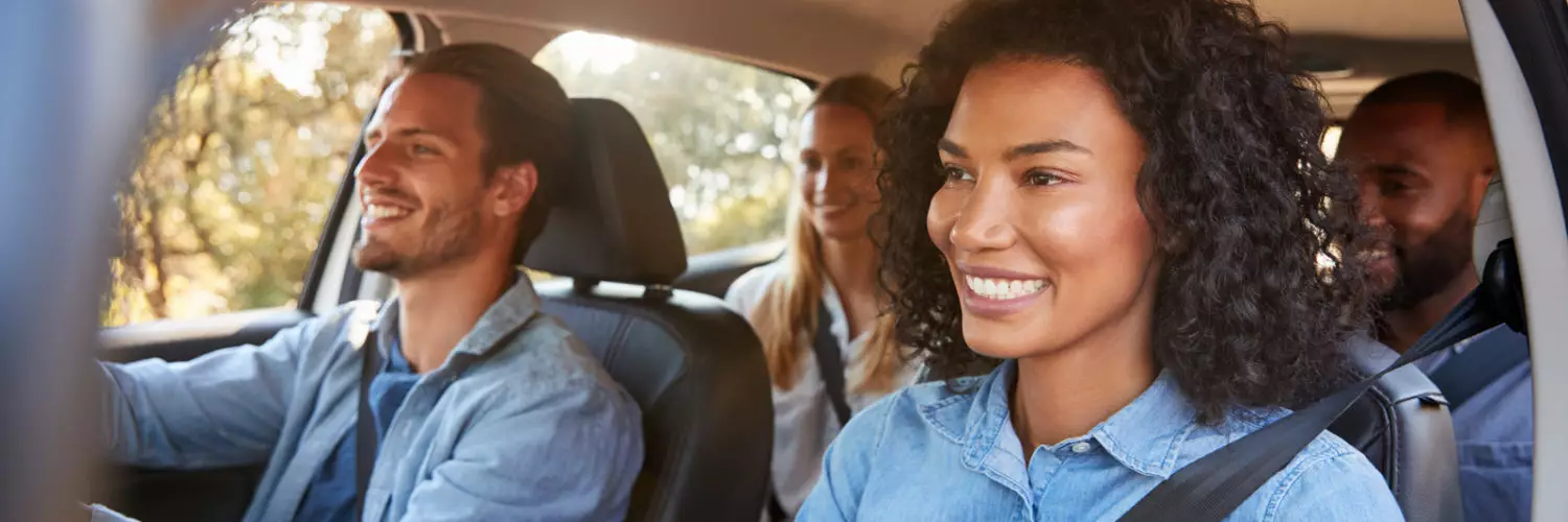 Group of happy people in a car