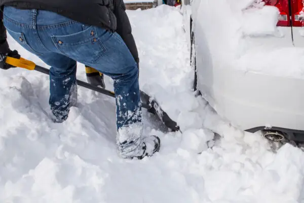 Shovelling snow from under car