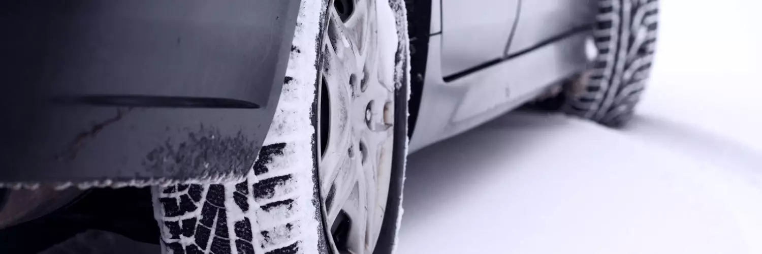 Vehicle winter tires on a snowy road