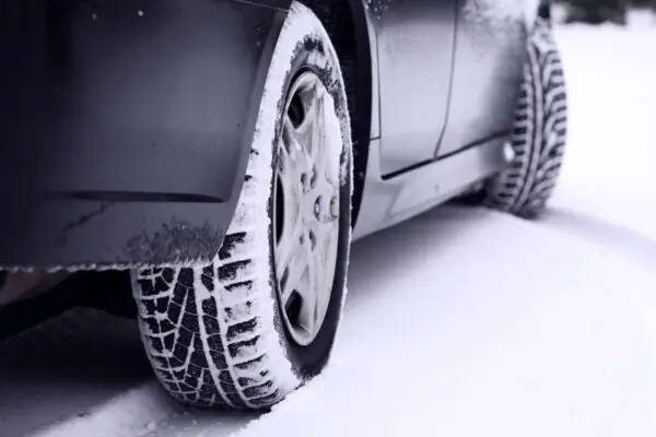 Vehicle winter tires on a snowy road