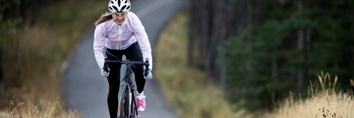 Woman biking on path