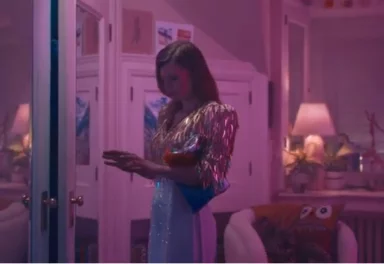 Woman in her room dressed up and texting