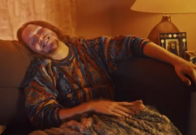 Man sitting on couch after consuming cannabis