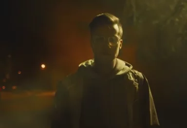 Man with glasses outside at night
