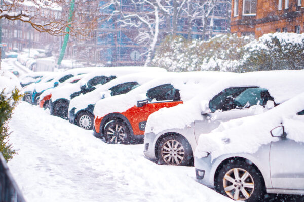 Parked cars covered in snow
