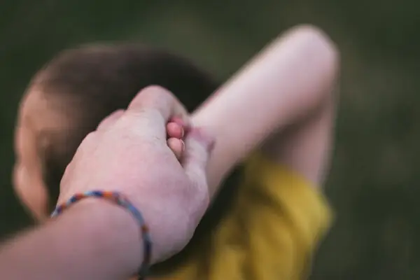 Parent holding child's hand