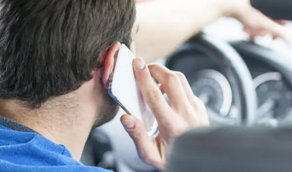 man talking on the phone while driving